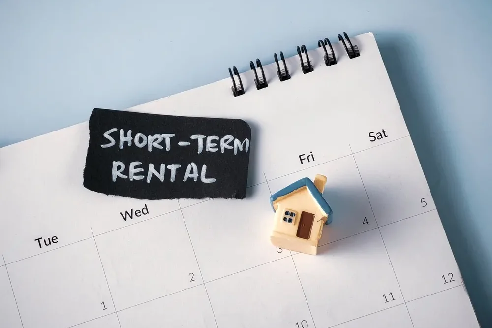 Miniature,House,On,Calendar,With,"short-term,Rental",Text:,Concept,For
